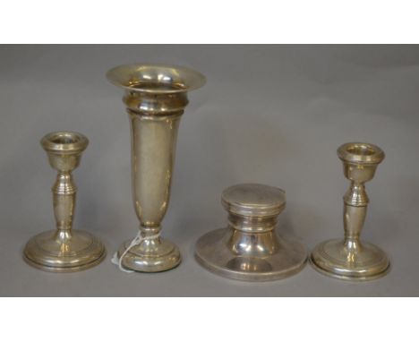 Hallmarked Silver items: a vase, a pair of dwarf candlesticks and a capstan inkwell. Height of vase 15.5cm approx. (4) (VAT O