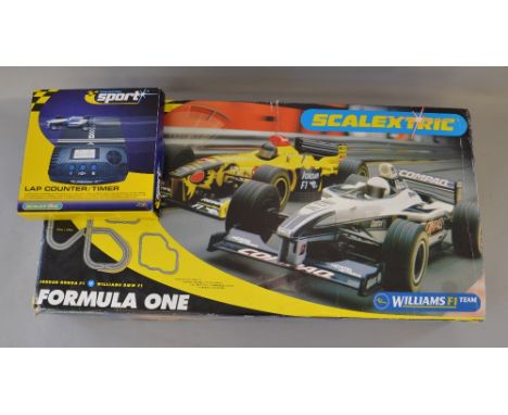 Scalextric Formula One racing set, appears complete, unchecked. Together with boxed lap counter/timer. VG in F boxes.