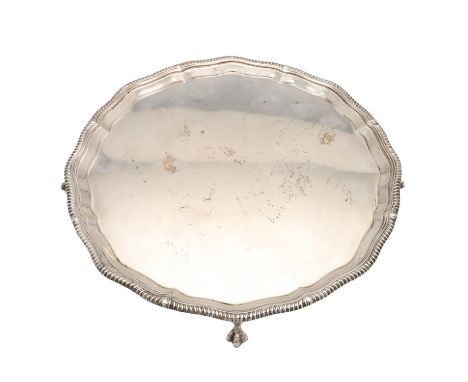 of shaped circular outline, with a gadrooned border and on four ball &amp; claw feet, by Goldsmiths &amp; Silversmiths Co. Lt