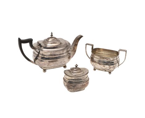 rounded rectangular form, with angular handles and on ball feet, the tea pot with a presentation inscription and lacking its 