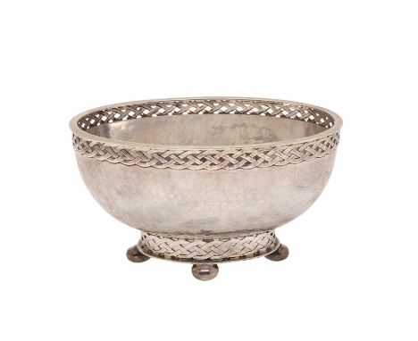 of oval form, with Celtic band borders, a spot-hammered finish and on four bun feet, the base with the makers facsimile signa