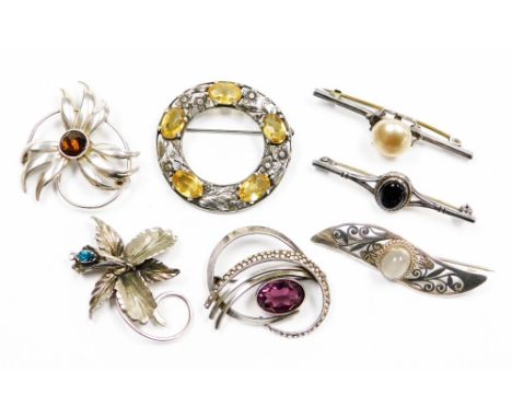 A group of silver and other brooches, to include a circular Celtic silver brooch with citrines, a STG silver sunflower brooch