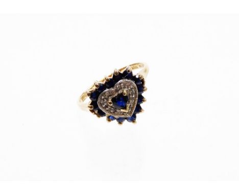 A 9ct gold dress ring, with heart shaped centre with a sapphire surrounded by illusion set tiny cz stones and outer blue sapp