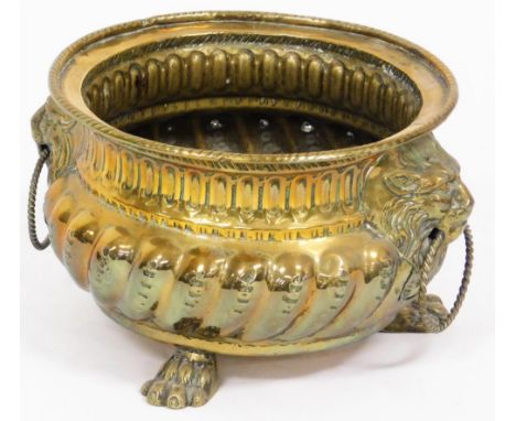 A Dutch brass lion mask bowl, with fluted body and lion mask handles with ring supports, on tripod claw feet, 15cm high, 12cm
