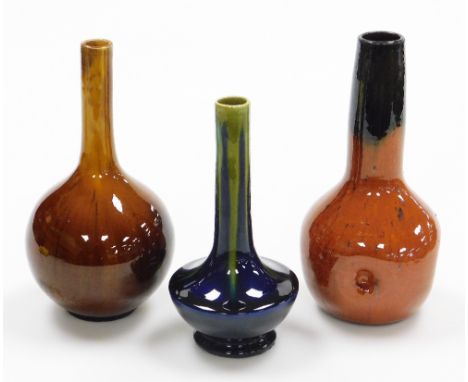 Three Studio Pottery stem vases, the orange fluted example marked Belgium 22cm high, another on a blue and green ground numbe