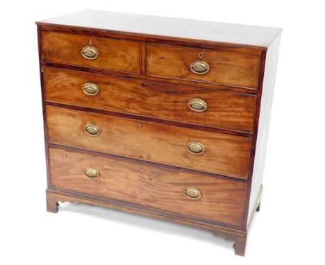 A George III mahogany chest of drawers, with a moulded edge, above two short and three long drawers, each with oval pressed b