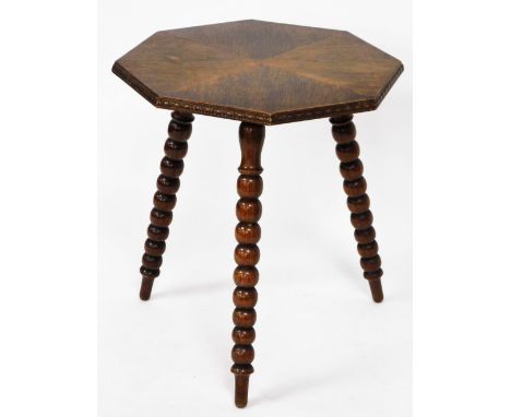 An oak gypsy table, with four diamond cut top on tripod hall legs with carved borders, 58cm high, 57cm wide. 