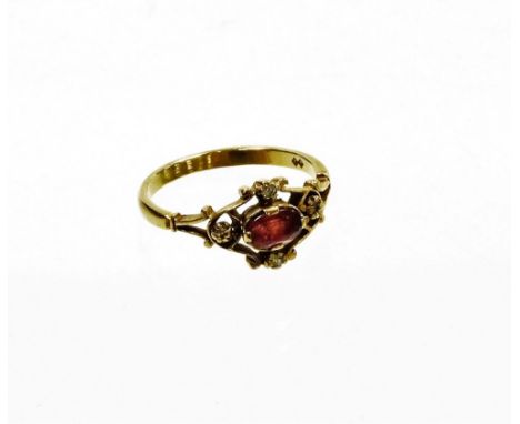 A 9ct gold dress ring, with central design of an oval ruby, in a rub over setting, with pierced and open work flower four poi