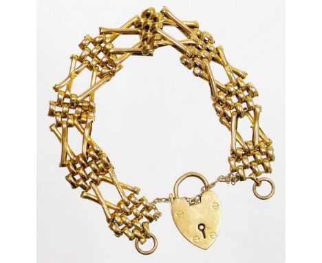 A 9ct gold gate bracelet, of four row and two row cross link design, with safety chain and a heart shaped padlock, 16cm long,