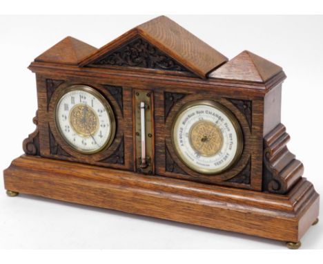 A late Victorian oak aneroid barometer and clock, in architectural case, with fret work cornice above columns on a fret base,
