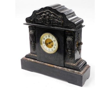 A late 19thC black slate mantel clock, with cherub urn and Medusa carved panels, with a cream dial, 49cm high, 50cm wide, 19c