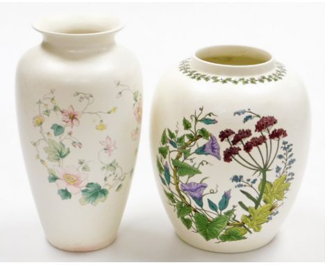 Two Poole pottery vases, to include one with blue bell design, signed G Breeze, and another taller stem vase with pink daisie