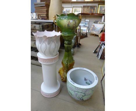 Two porcelain jardinieres on stands and a ceramic fish bowl 