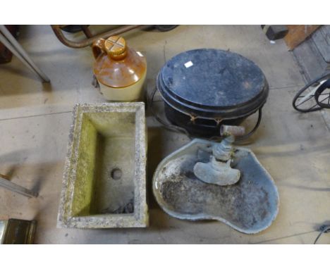 A concrete garden planter, a metal cauldron, a cast iron feeding bowl and a stoneware flagon 