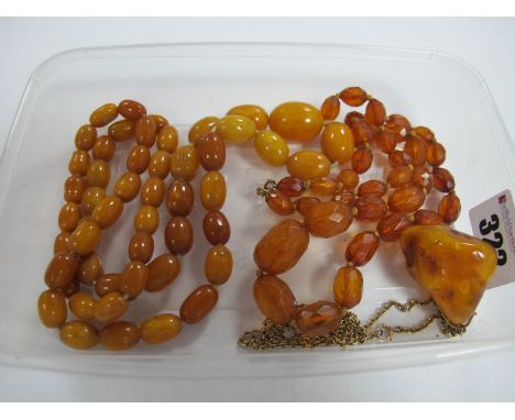 A Butterscotch Amber Graduated Bead Necklace, together with a faceted bead necklace and an amber pendant on chain. 