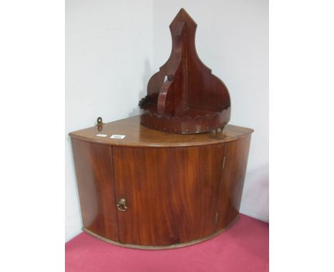 A XIX Century Small Mahogany Bow Fronted Corner Cupboard, together with an early XX Century mahogany wall bracket. (2) 