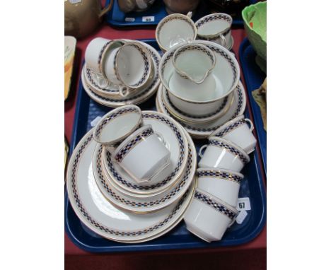 An Early XX Century Diamond China Tea Service, decorated with gilt and cobalt blue geometric band on a white ground (approxim