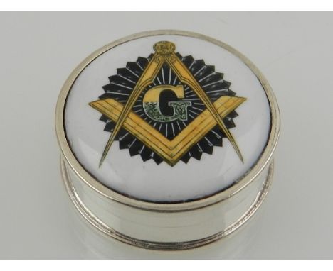 A sterling silver circular pill box, the enamel lid with a Masonic design. 