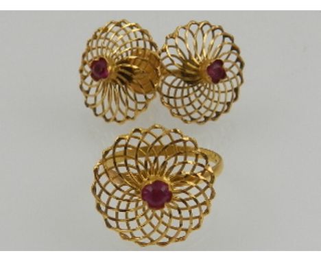 A 22 carat yellow gold and ruby set ring of latticed floral design, together with a matching pair of 22 carat yellow gold and