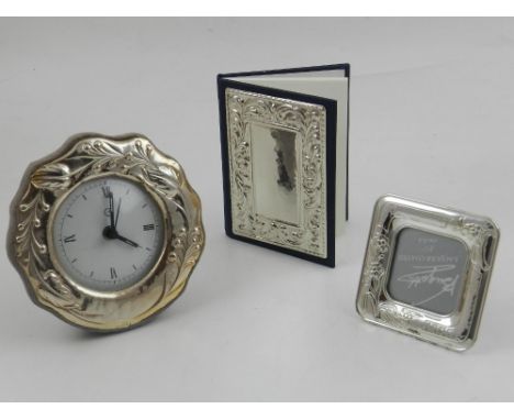 A white metal mounted address book, the cover with a foliate repousse panel stamped 925, together with white metal mounted ma