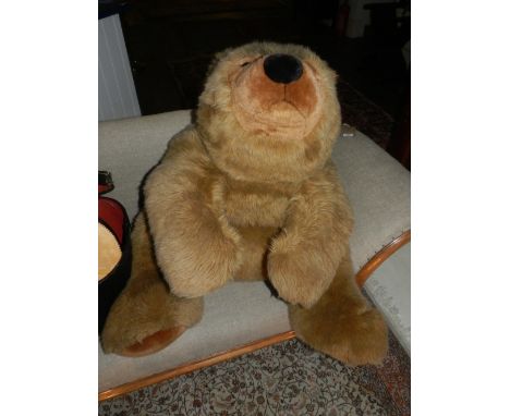 An oversized Steiff teddy bear, with brown fur. 