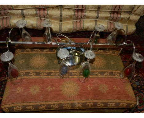 A chrome champagne glass holder, made as a ceiling light. W.76cm
