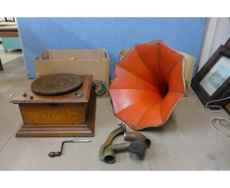 An gramophone with red metal horn speaker and a collection of records 