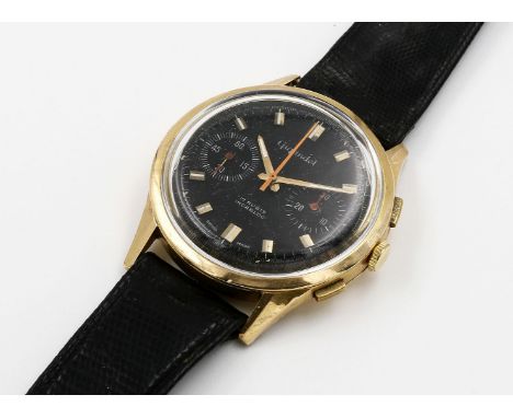 Herrenarmbanduhr mit Chronograph "Gigandet". Rundes 750/000 GG-Gehäuse mit aufgedrücktem Boden, teils gedellt. Schwarzes Ziff