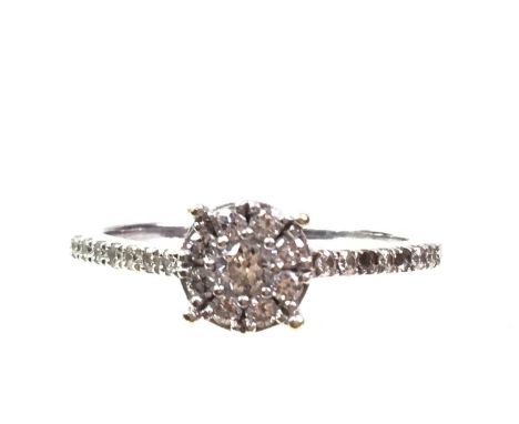 DIAMOND CLUSTER RING, set with small round brilliant cut diamonds, in fourteen carat white gold, size OQty: 3.1g
