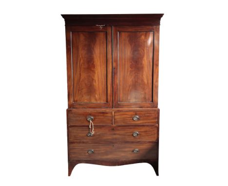 A GEORGE III MAHOGANY LINEN PRESS, the top section with a moulded cornice above two recessed panel doors, opening to reveal a