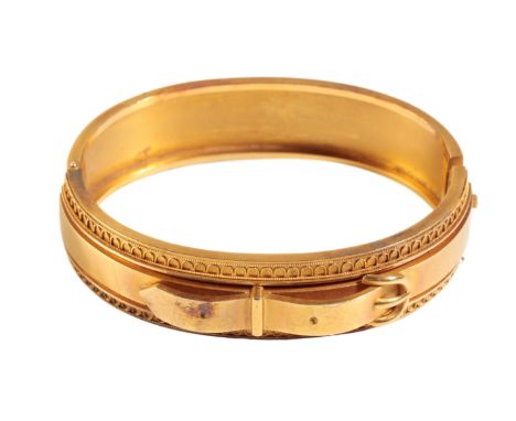 AN ETRUSCAN STYLE HINGED GOLD BANGLE, with belt buckle decoration to the front, unmarked, (tests as 15ct), approx 23.4grams