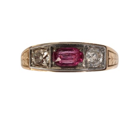 A RUBY AND DIAMOND RING, the oval facet-cut ruby, flanked either side with an old-cut diamond, on an unmarked yellow metal sh