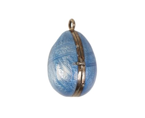 A FABERGE STYLE  ENAMELED EGG PENDANT / LOCKET, the blue guilloche enamel ground with unmarked yellow metal hinge opening to 