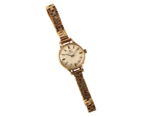 AN OMEGA LADY'S 9CT GOLD BRACELET WATCH, with manual wind movement, the silver dial with gold batten numerals and dark blue s