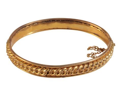 A VICTORIAN  HINGED GOLD BANGLE, with embossed twist decoration, concealed clasp, and safety chain, (tests as 15ct), approx 9