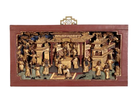 A CHINESE CARVED WOOD RELIEF,, decorated in polychrome and gilt, of figures in an and around elegant garden buildings, with f