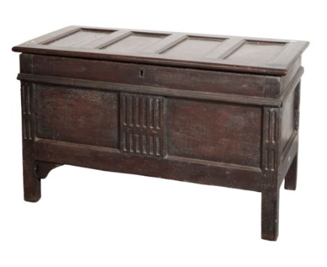 A SUBSTANTIAL JACOBEAN OAK COFFER,, late 17th century, with four panel hinged cover and twin panel front, the centre with sty