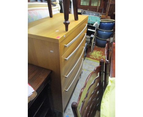 A modern light wood chest of four graduated drawers with textured white coloured handles and matching metal legs 122cm x 90cm