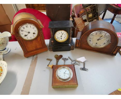 Four clocks to include a J. Schuler and Sons oak cased mantel clock, an inlaid walnut clock with Junghans movement, a Bullnos