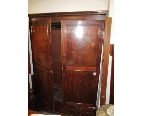A George III mahogany linen press, converted to a wardrobe, dentil moulded cornice over twin doors with internal brass hangin