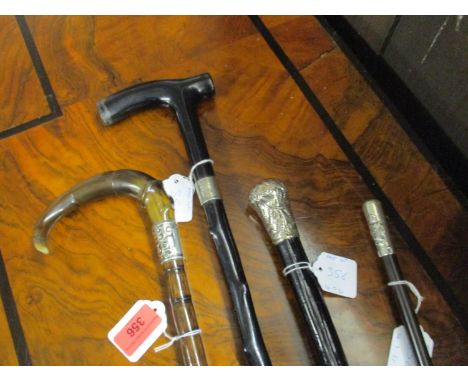 Three walking sticks to include one with a horn handle and silver collar, Chester 1910, one with Birmingham makers mark AZ an