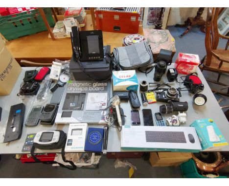 A mixed lot of electronics and cameras to include an I-Phone 6, Dell laptop battery, Nikkormat camera and extra lens, Tamron 