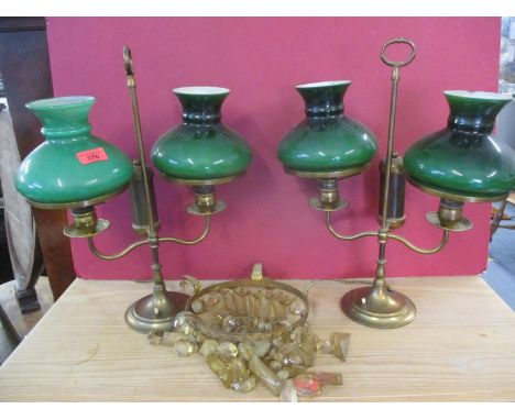 A pair of mid 20th century table lamps in the style of library oil lamps with green glass shades together with an early 20th 