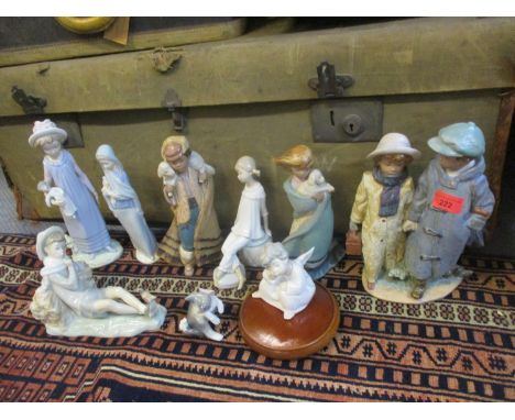 A group of Lladro figures to include Gres examples, together, with a Lladro model of a cat having a mouse balanced on its tai