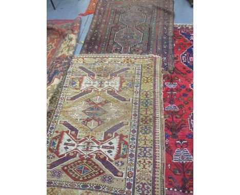 Three Middle Eastern rugs, hand woven, to include a brown ground rug with tassels 155cm x 108cm, a light brown and cream grou