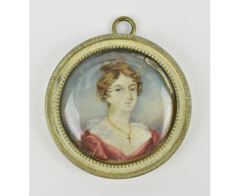 Four British School, late Georgian portrait miniatures to include of a young lady on ivory, a seated lady wearing a feathered