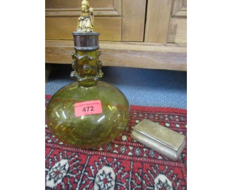 A coloured glass decanter with an adapted lid in the form of a netsuke, having a silver collar together with an engine turned