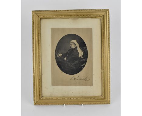 A framed portrait of Queen Victoria, with facsimile signature and date 1885 lower right, within a glazed and giltwood frame 