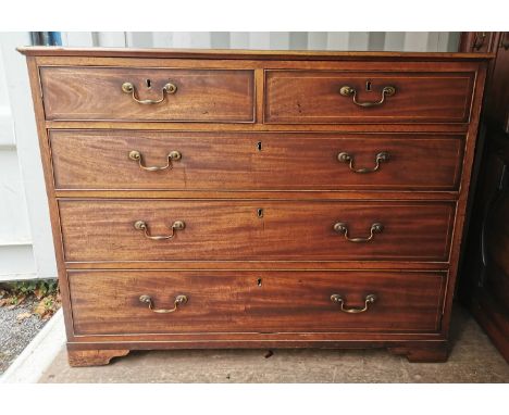 A George III straight fronted mahogany chest of drawers, with two short drawers over three graduated long drawers, with strin
