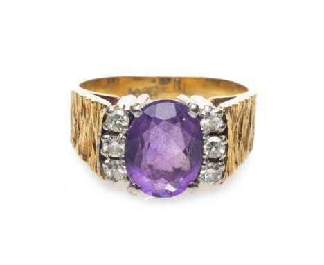 18CT GOLD AMETHYST & DIAMOND CLUSTER RING, the central oval amethyst (9 x 6mms) complimented by six claw set round cut diamon